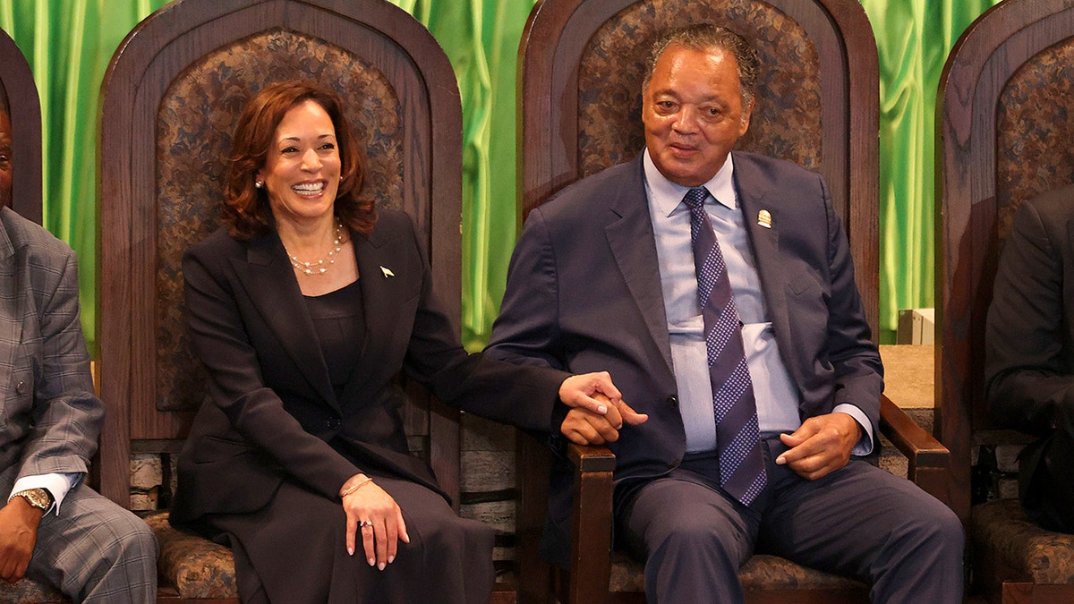 Vice President Kamala Harris holds Rev. Jesse Jackson's hand in 2023