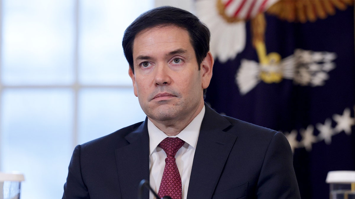 U.S. Secretary of State Marco Rubio stands attentively in the East Room during a meeting with energy industry leaders at the White House.