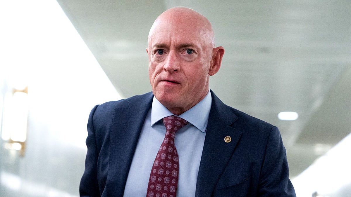 Sen. Mark Kelly walks through the Dirksen Senate Office Building in Washington, D.C.