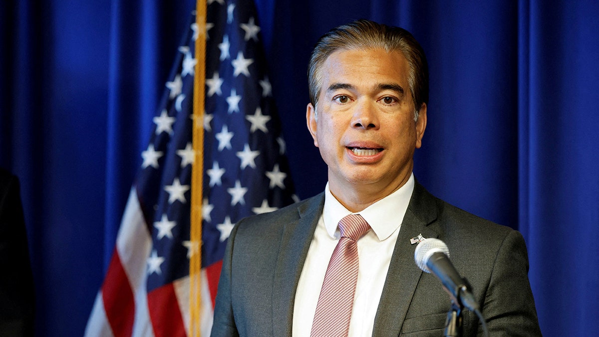 Rob Bonta speaking in front of American flag
