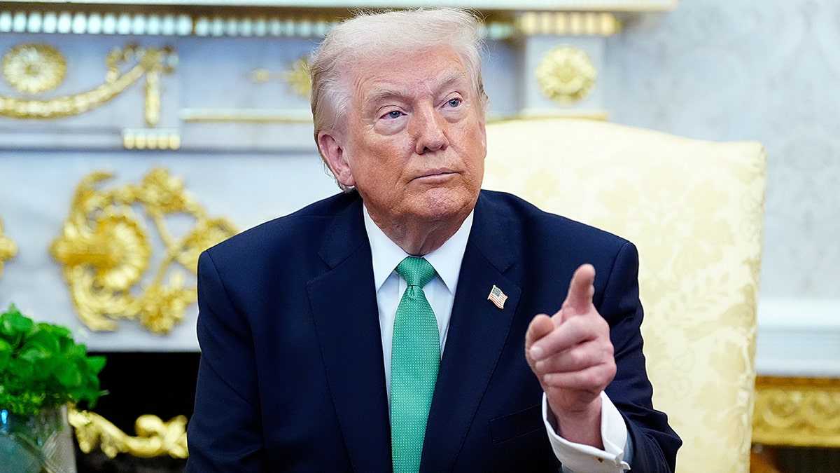 President Trump points to a reporter in the Oval Office