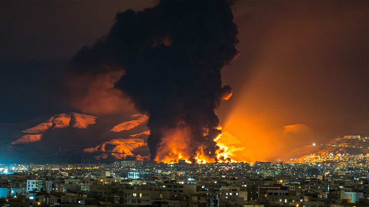 Smoke and flames rise at the site of airstrikes on an oil depot in Tehran on March 7, 2026. The United States and Israel launched strikes against Iran on February 28, prompting Iranian retaliation with missile attacks across the region and intensifying concerns about disruption to global energy and transport.