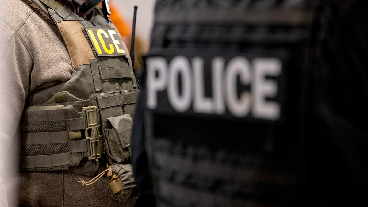ICE officers with logos on gear