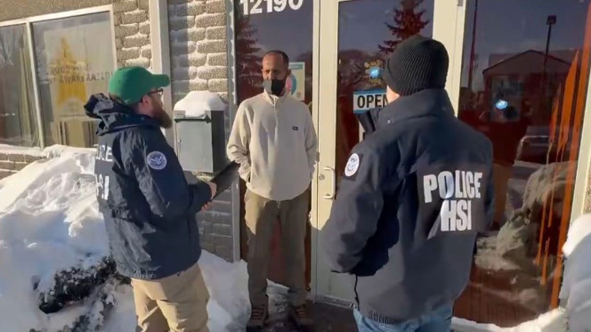 Federal agents question a man in Minneapolis