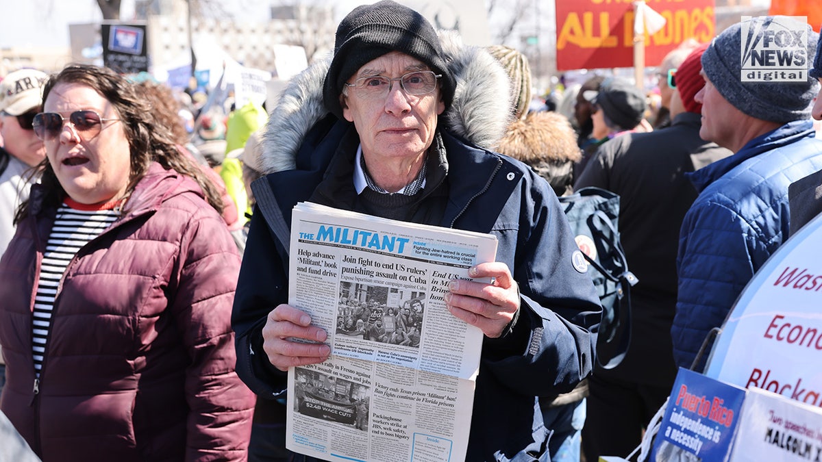 Kevin Dwire from the Socialist Workers Party holds "The Militant" newspaper