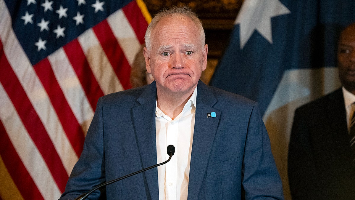 Minnesota Gov. Tim Walz grimacing during a press conference.