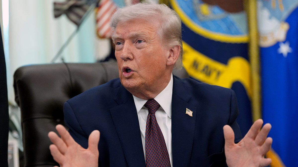 President Donald Trump speaks with reporters in the Oval Office