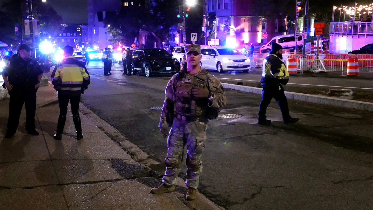 Police and National Guard stand in front of the Washington Hilton after the White House Correspondents Association Dinner was postponed April 25, 2026 in Washington, DC.