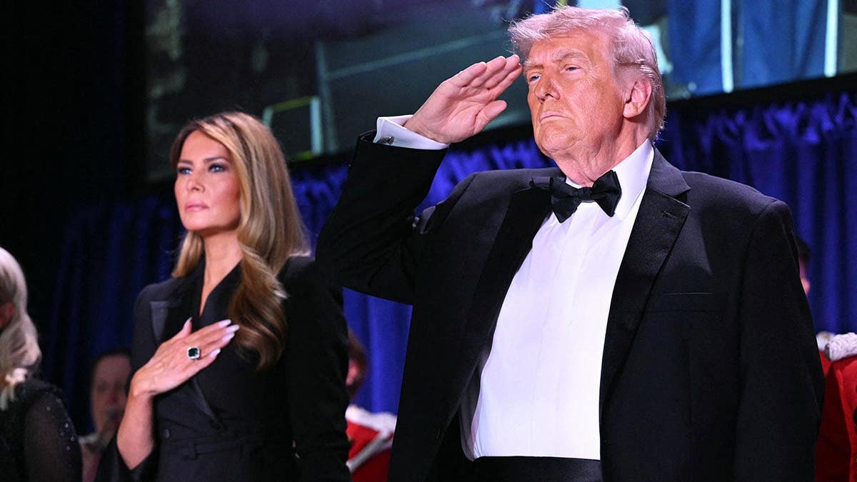 First Lady Melania Trump and President Donald Trump standing together at the White House Correspondents' dinner.