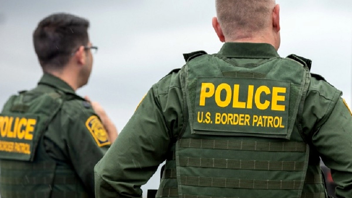 U.S. Border Patrol officers standing outdoors in uniform