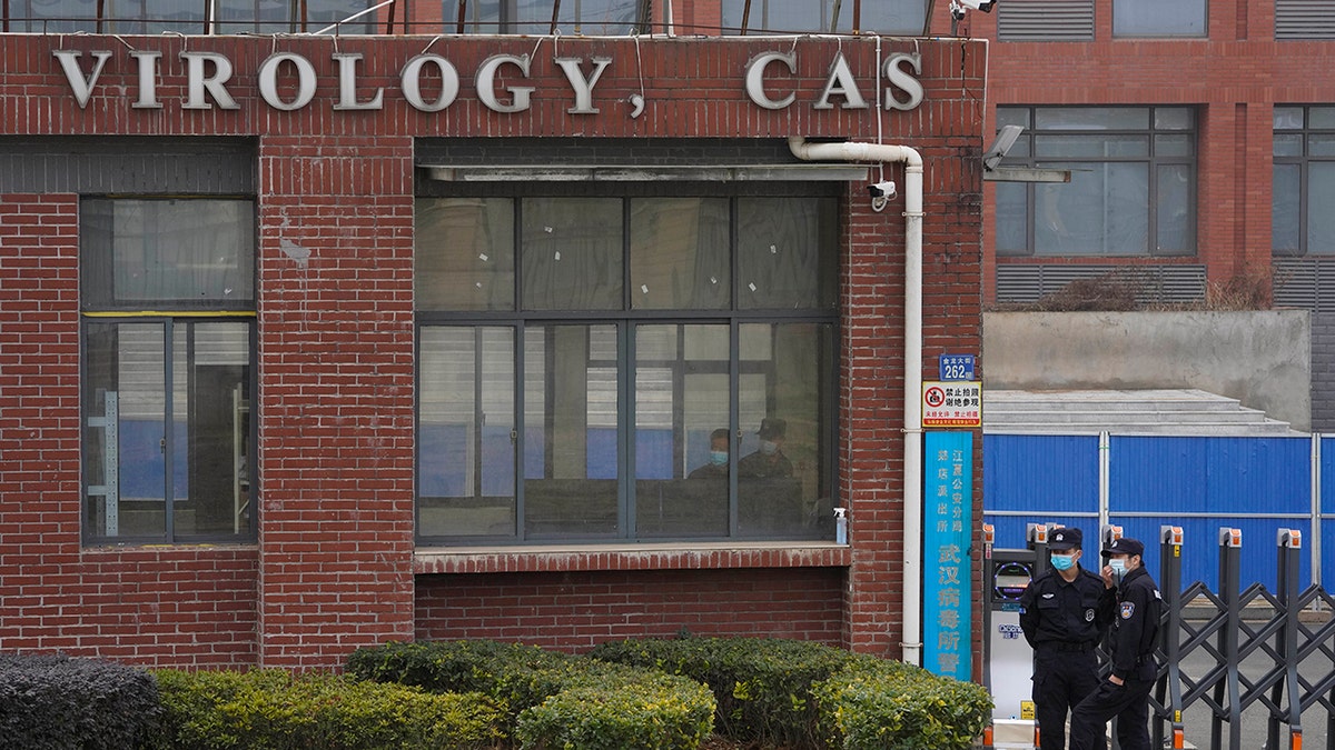 Security personnel standing near entrance of Wuhan Institute of Virology in China