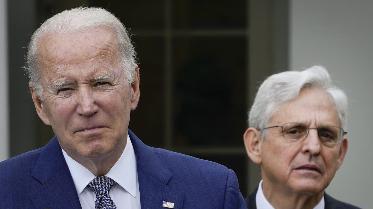 Attorney General Merrick Garland looking on as President Joe Biden speaks in the White House Rose Garden