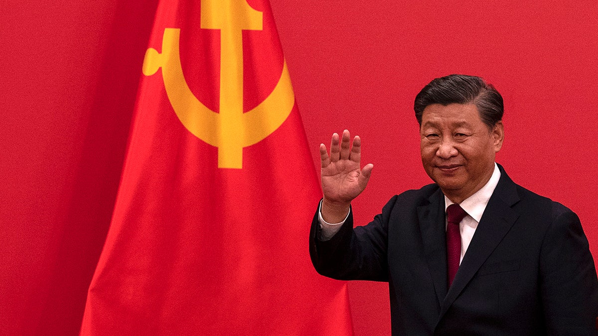 Chinese President Xi Jinping waving while leaving a press event at The Great Hall of People in Beijing