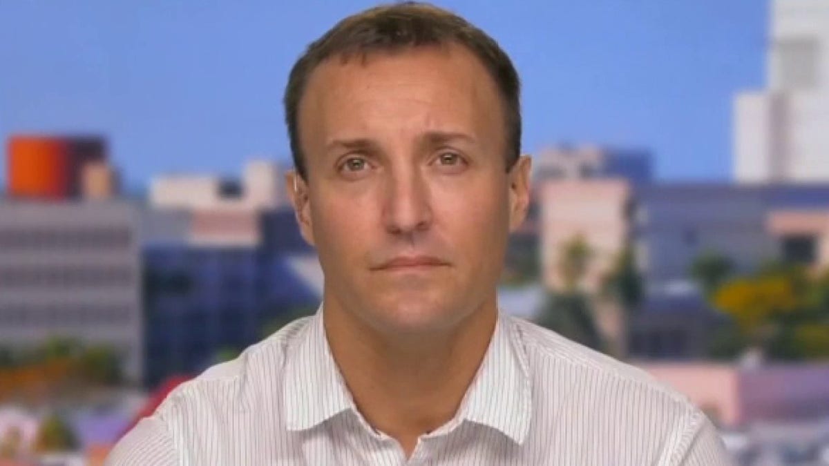 Stuart Scheller standing and speaking at a podium