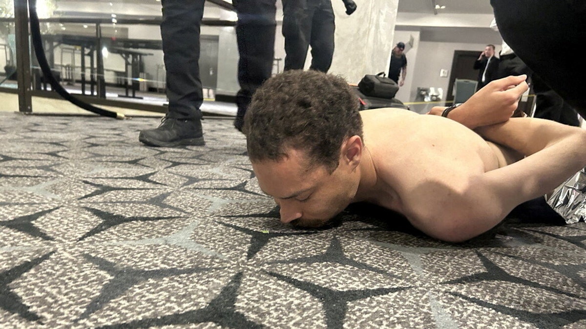 Law enforcement personnel detaining Cole Tomas Allen in Washington, D.C.