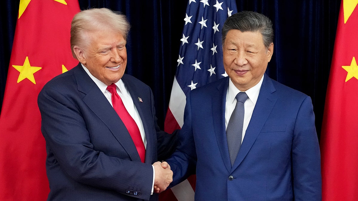 President Donald Trump shaking hands with Chinese President Xi Jinping at Gimhae Air Base