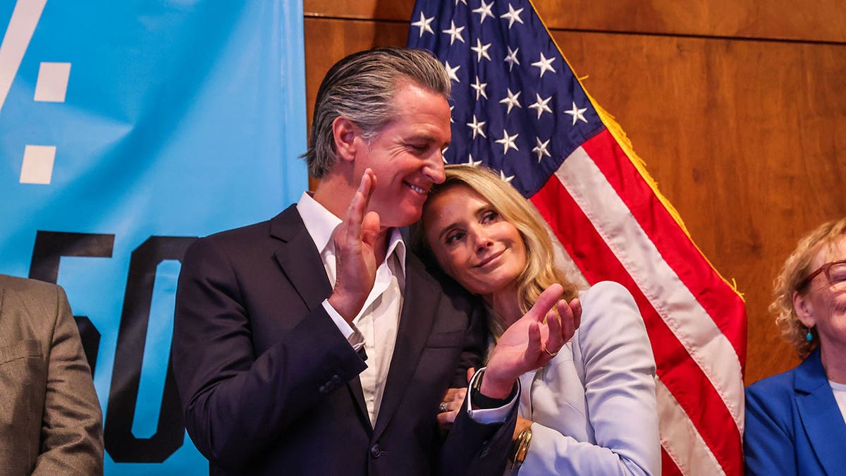 California Gov. Gavin Newsom and first partner Jennifer Siebel-Newsom embrace during a campaign event in support of Proposition 50 in San Francisco, Monday, Nov. 3, 2025.