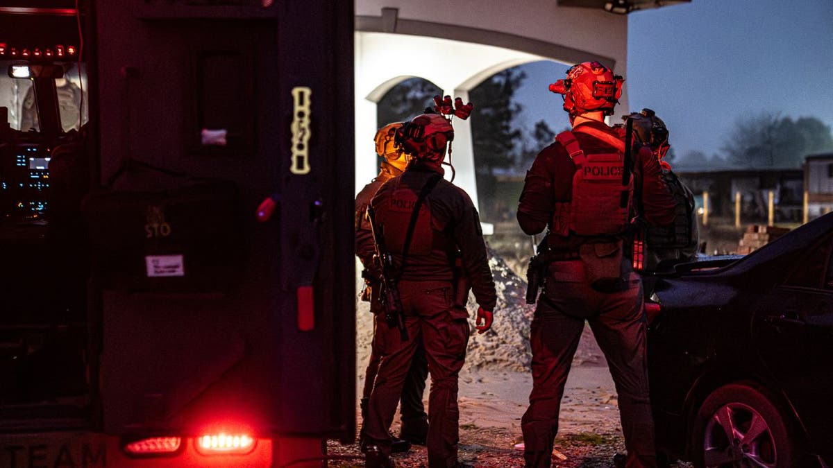 ICE officers escorting a detainee in Houston