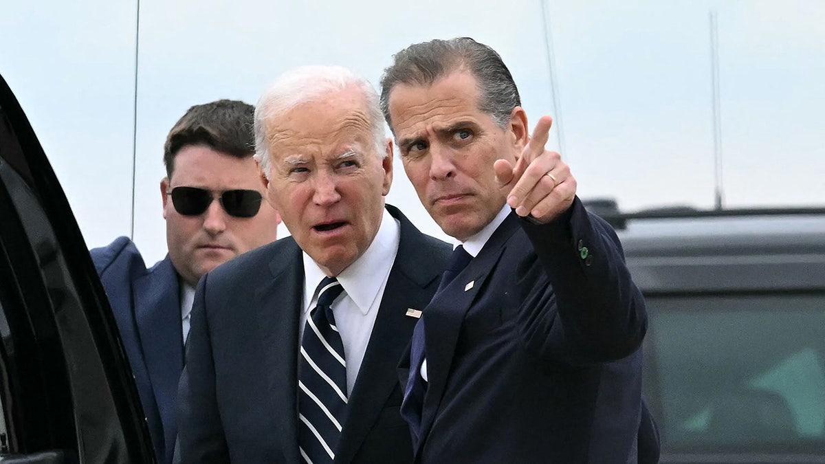 President Joe Biden talks with his son Hunter Biden at Delaware Air National Guard Base
