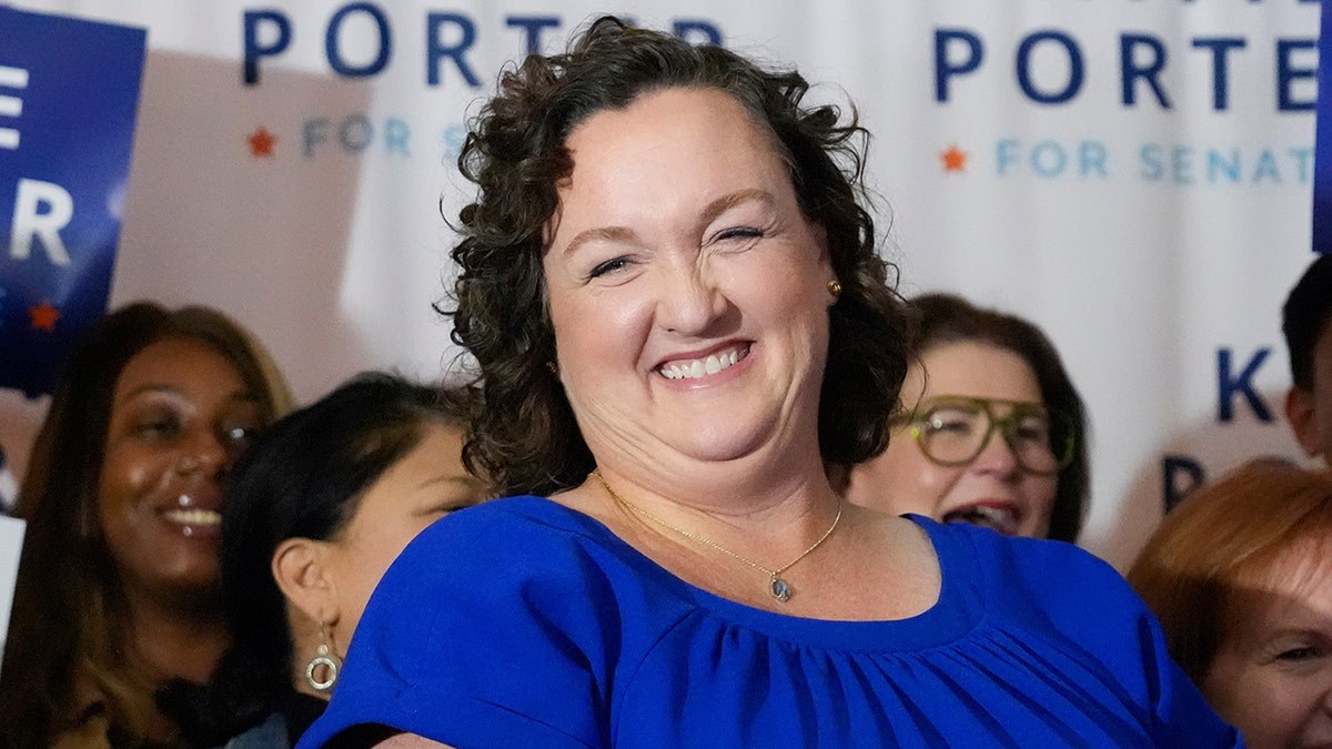 U.S. Rep. Katie Porter smiling while preparing to address supporters at an election night party