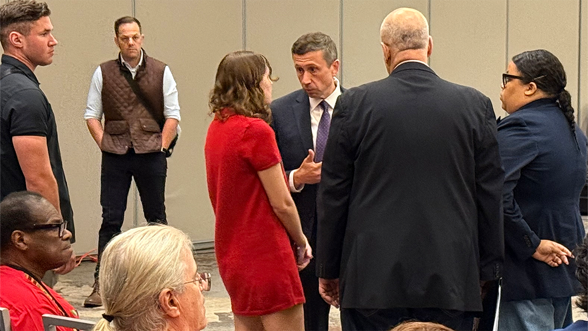 DNC Chair Ken Martin and Allison Minnerly huddle during a meeting