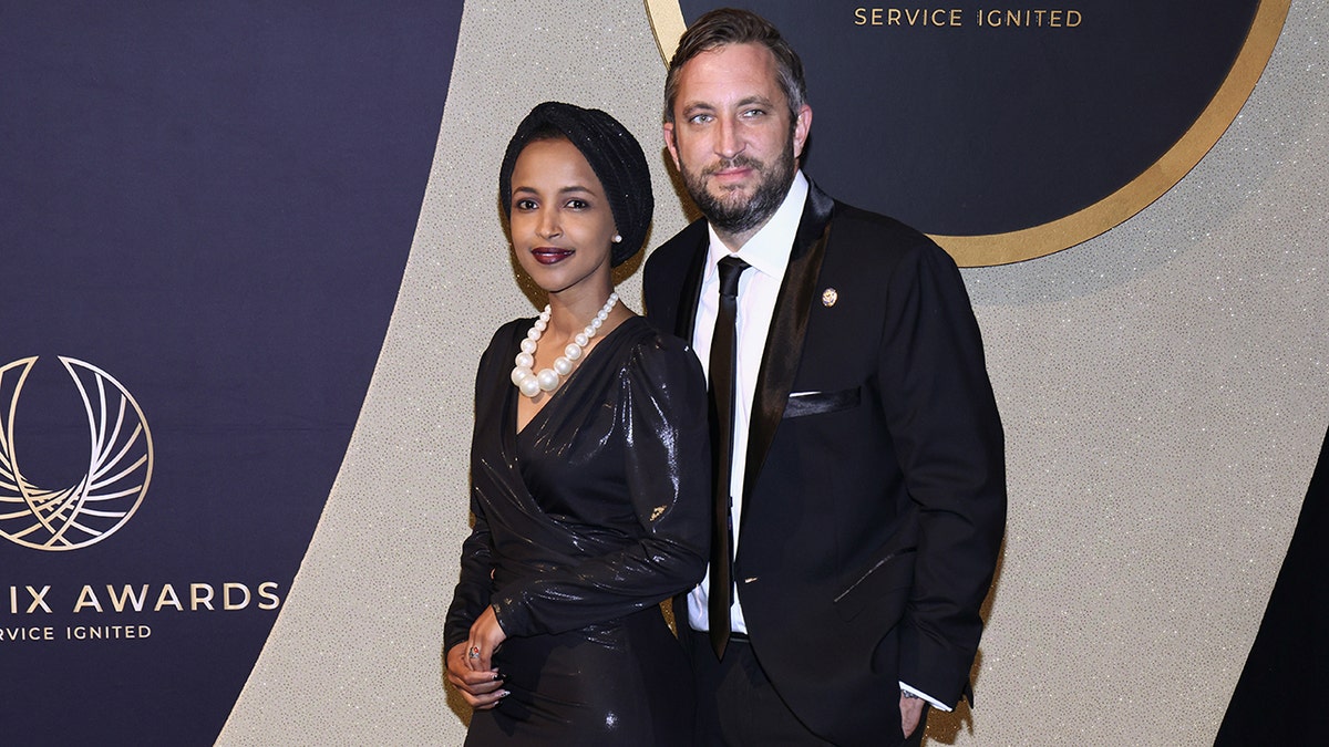 Rep. Ilhan Omar and husband Tim Mynett standing at the Congressional Black Caucus Foundation Phoenix Awards