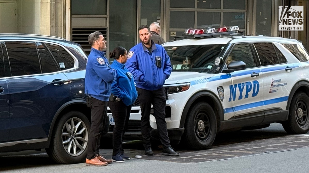NYPD Community Affairs officers standing across the street from the People's Forum in New York City