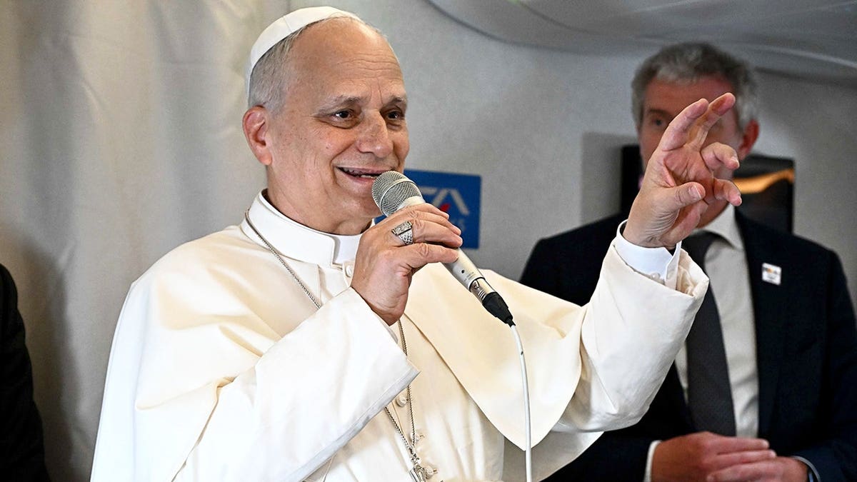 Pope Leo XIV answering journalists' questions on a plane.