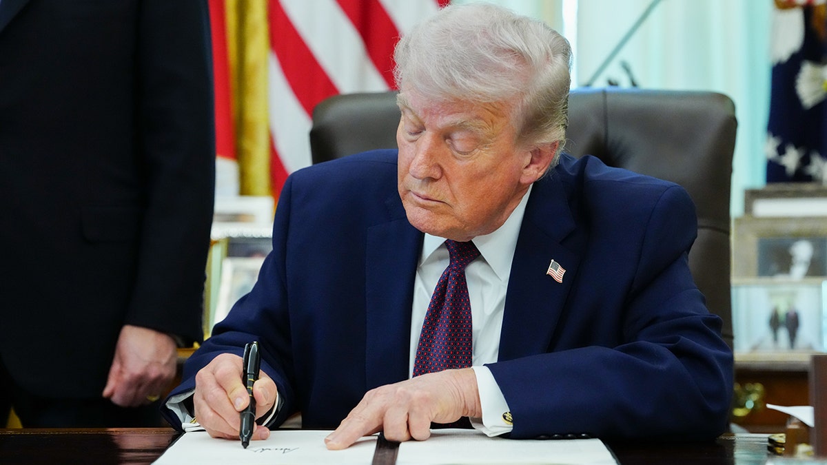 President Trump signs EO at Resolute Desk