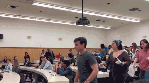 GIF of UCLA students protesting walking out of classroom