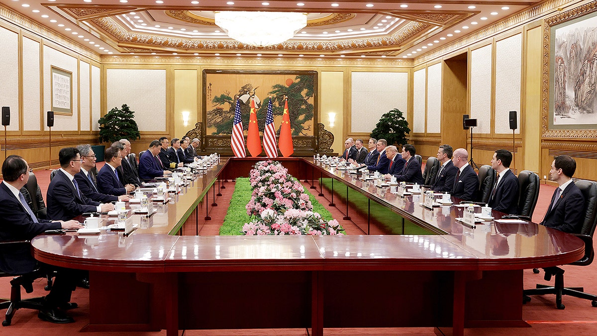 U.S. President Donald Trump and Chinese President Xi Jinping seated at a table during a bilateral meeting in Beijing