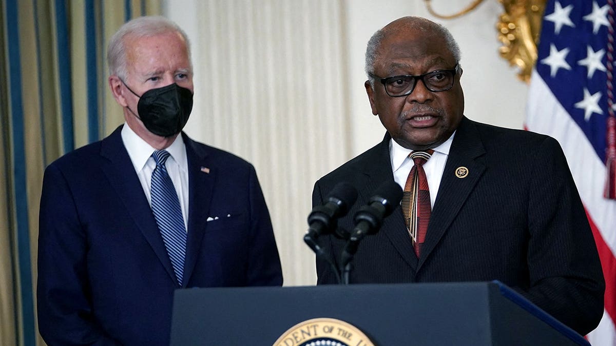 Biden in a mask with Clyburn looking offscreen