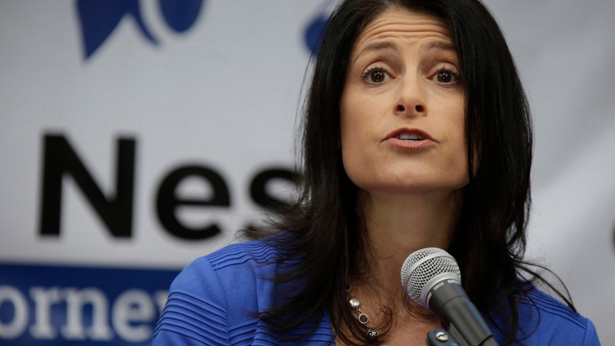 Attorney Dana Nessel standing with her family while announcing her bid for Michigan attorney general