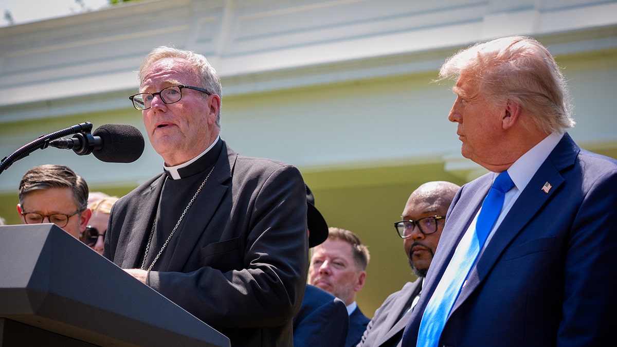 Bishop Robert Barron speaking at White House podium with President Donald Trump listening