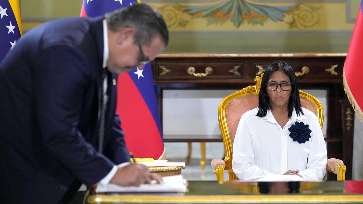 Chevron representative Mariano Vela signing agreement at Miraflores presidential palace in Caracas