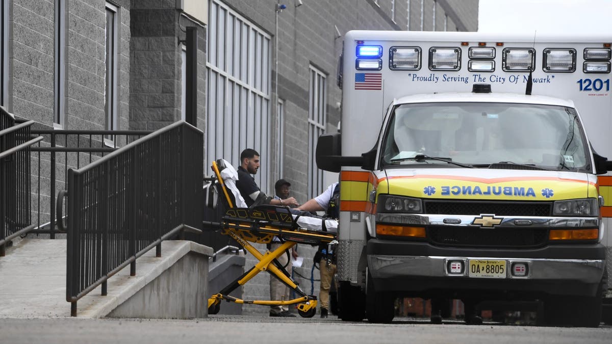 A person being taken out of Delaney Hall into an ambulance