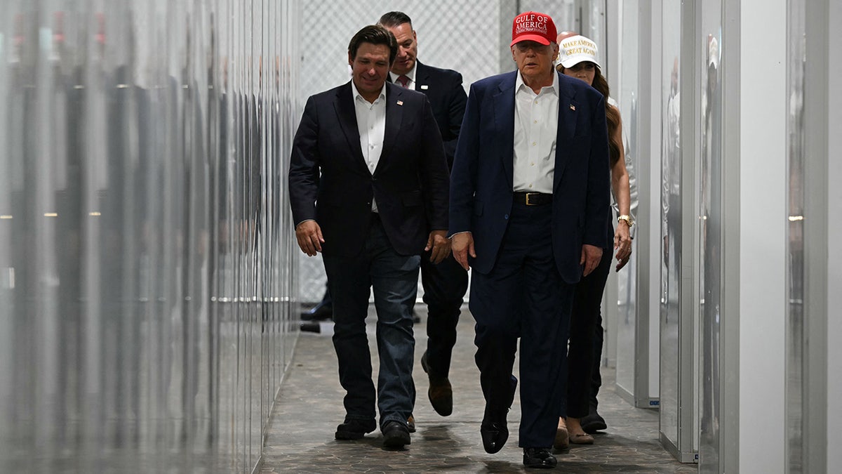 Ron DeSantis walking alongside Donald Trump at Alligator Alcatraz in Ochopee Florida
