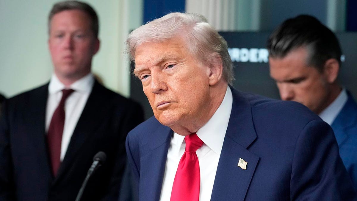 President Donald Trump listening to a question in the White House briefing room