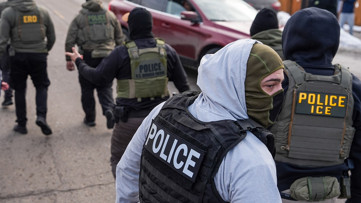 Federal agents walking during immigration enforcement operation in Minneapolis