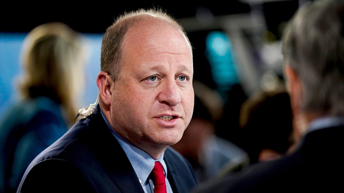Jared Polis speaking to media in spin room at CBS Broadcast Center New York