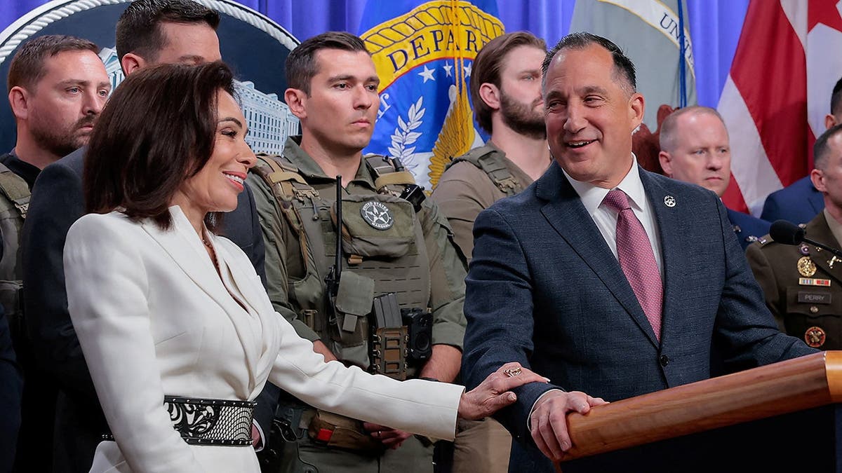 U.S. Attorney Jeanine Pirro touching U.S. Marshals Service Director Gadyaces Serralta's arm at a press conference