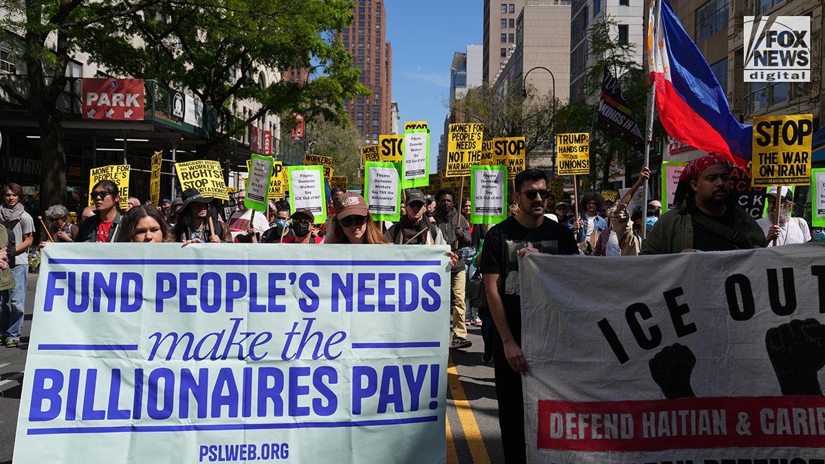 Activists hold up signs during May Day march in New York City, NY, Friday, May 1, 2026. (Fox News Digital)