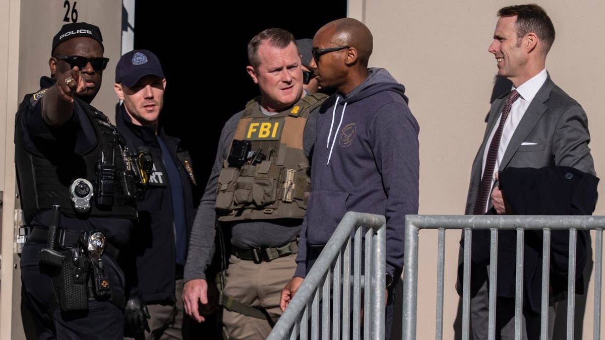 FBI agents standing outside the Fulton County Election Hub and Operation Center in Union City, Ga.