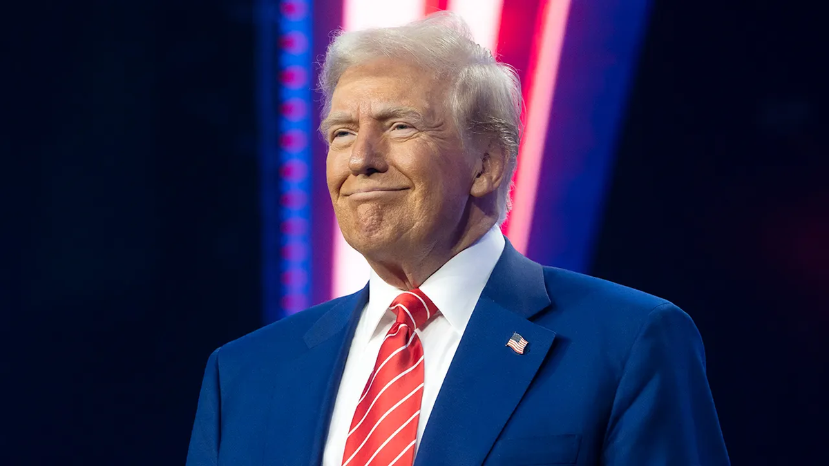 President Donald Trump smiling during AmericaFest at Phoenix Convention Center