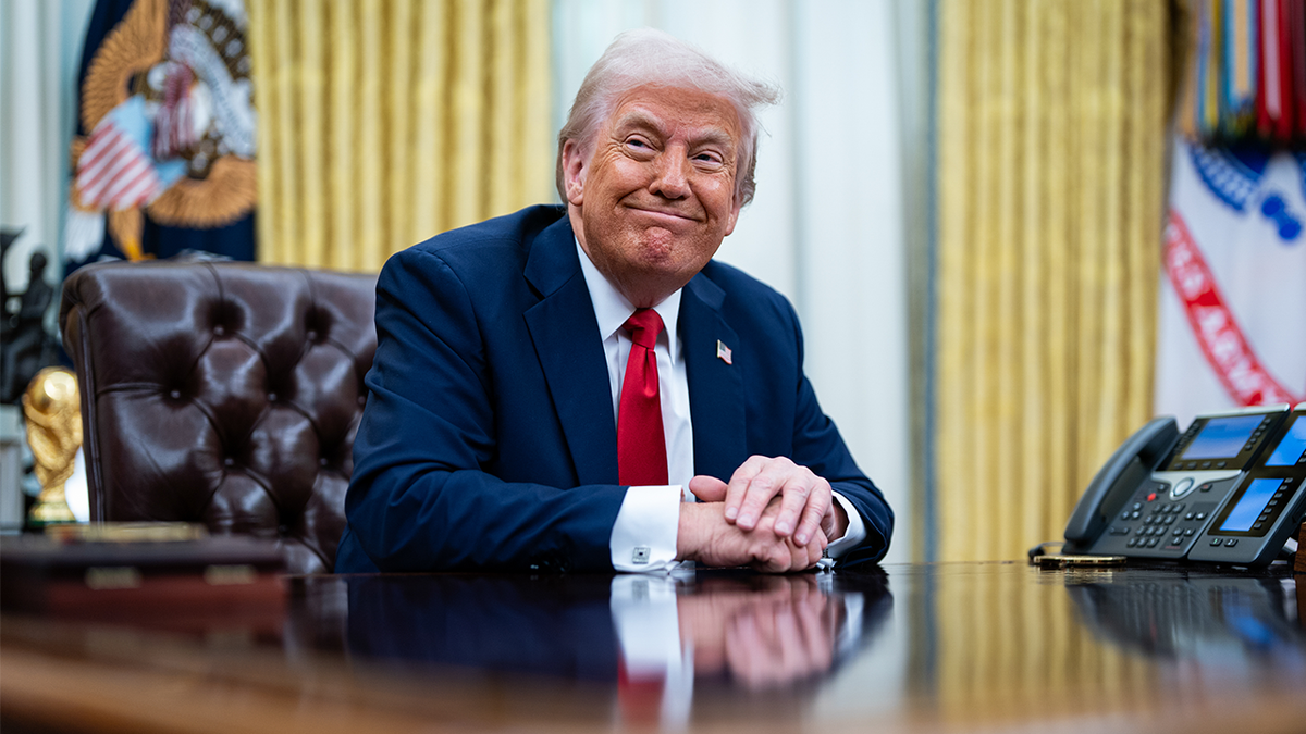 President Donald Trump signing an executive order in the Oval Office of the White House