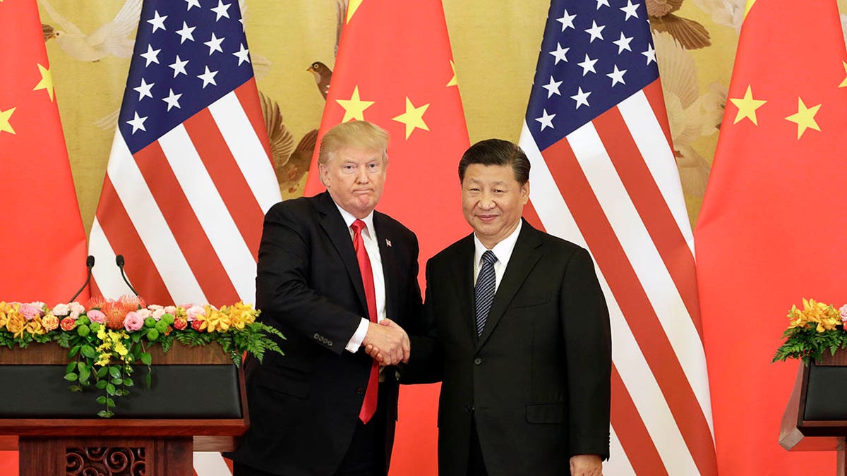 President Donald Trump and Xi Jinping shaking hands at the Great Hall of the People in Beijing