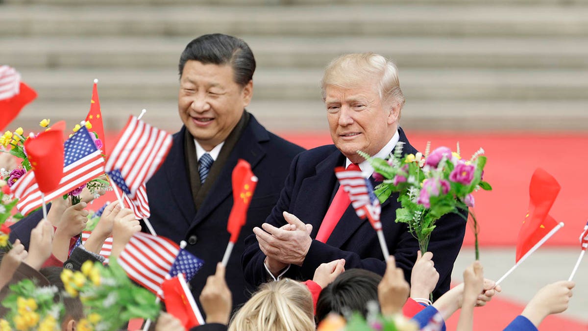 U.S. President Donald Trump and China's President Xi Jinping greeting attendees outside the Great Hall of the People in Beijing