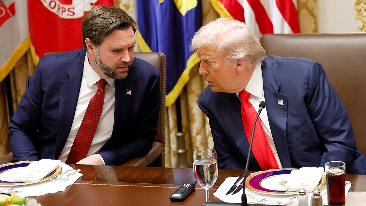 President Donald Trump speaking with Vice President JD Vance in the White House Cabinet Room