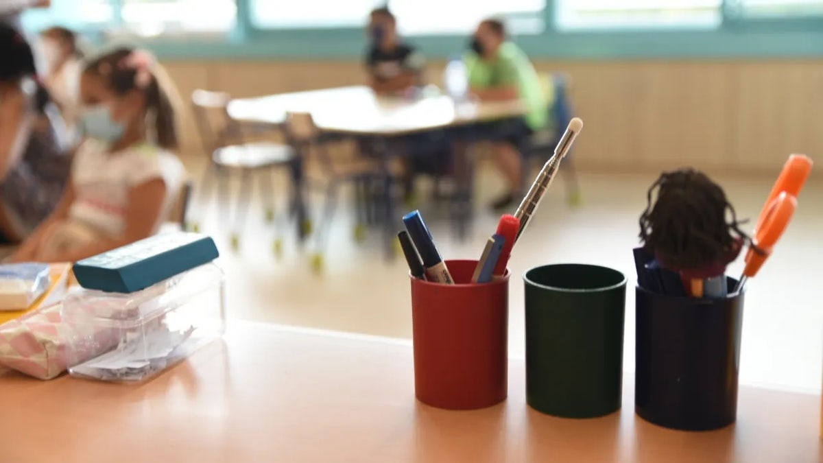 Virginia mom standing in classroom with students