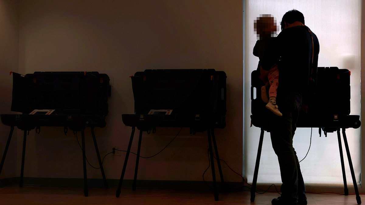 Voters casting ballots at vote centers in West Lafayette, Ind.
